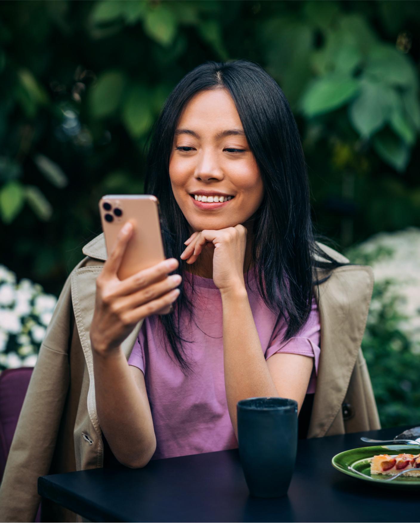 woman looking at phone on patio