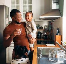 father and daughters in kitchen
